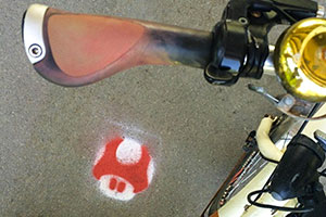 A Mario Kart symbol painted on the pavement.