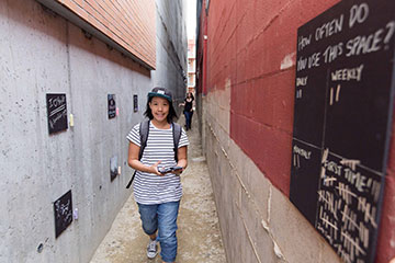 A girl walks down an Edmonton alley
